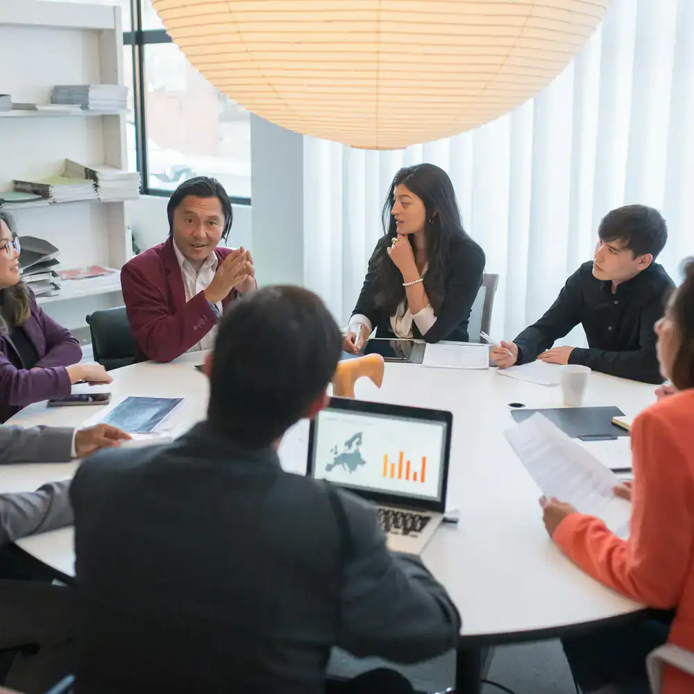 Business team collaborating around a conference table in a well-lit office